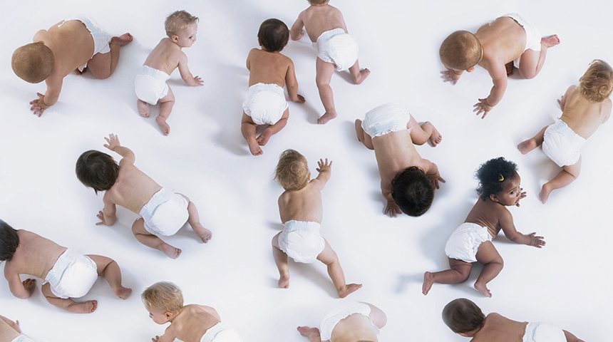 a group of crawling babies wearing baby diapers