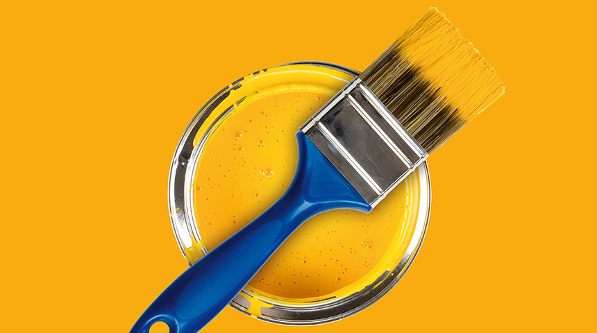 Yellow paint can with brush