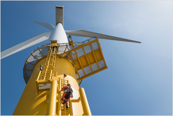 Engineers climbing a wind turbine