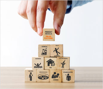 Close up of hand adding a wooden cube on top of a cube pyramid