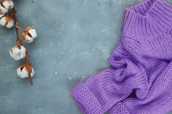 purple sweater with cotton plant